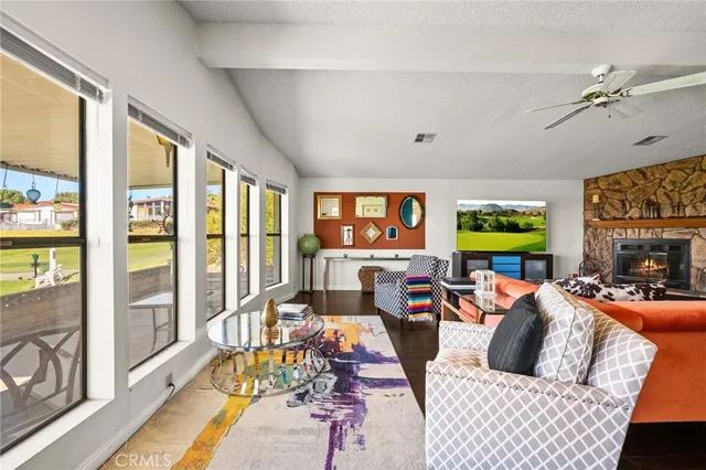 a dining room with wooden floor a chandelier a glass table and chairs