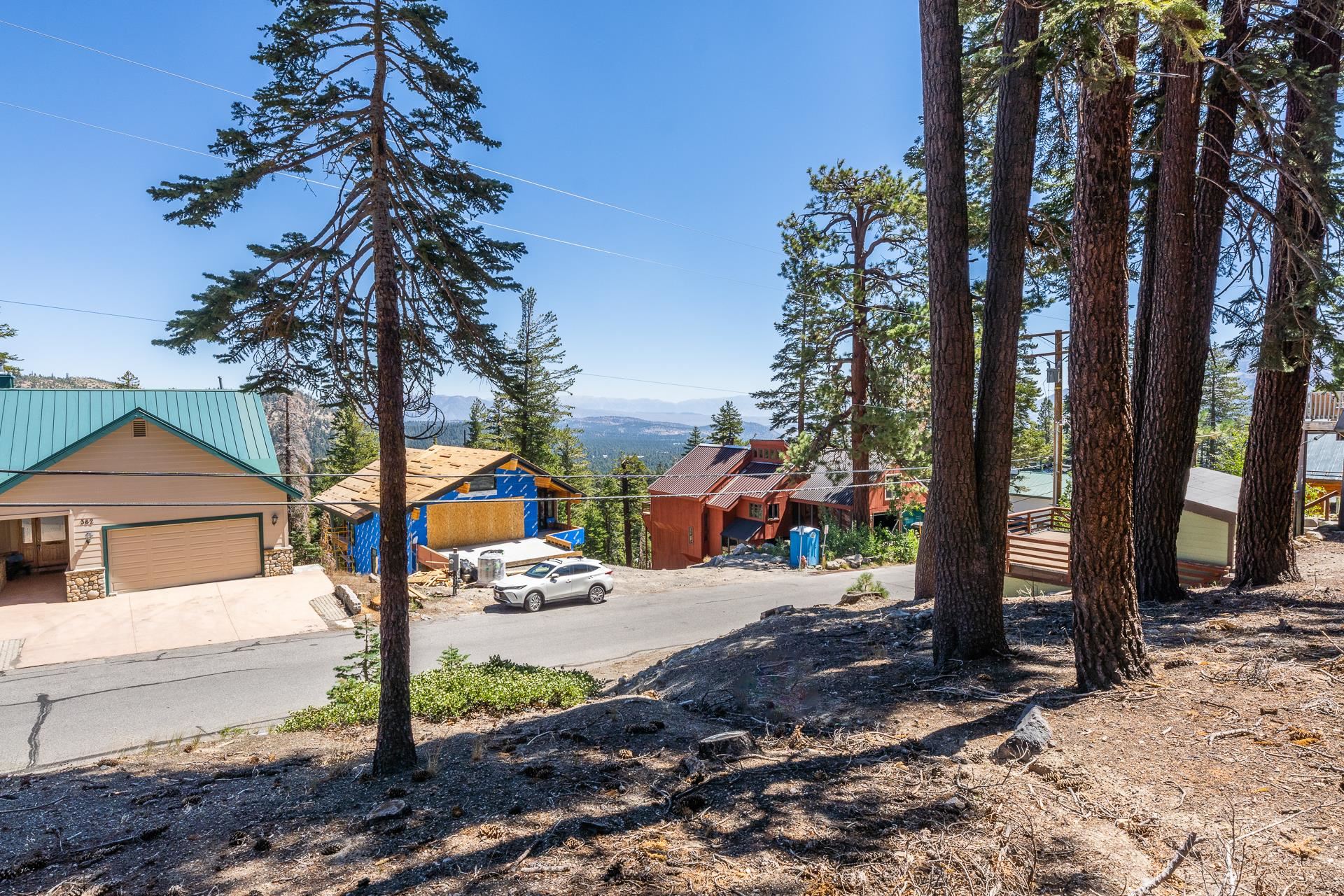 381 John Muir Road Mammoth Lakes, CA 93546 - Photo 18 of 23 a street view with large trees