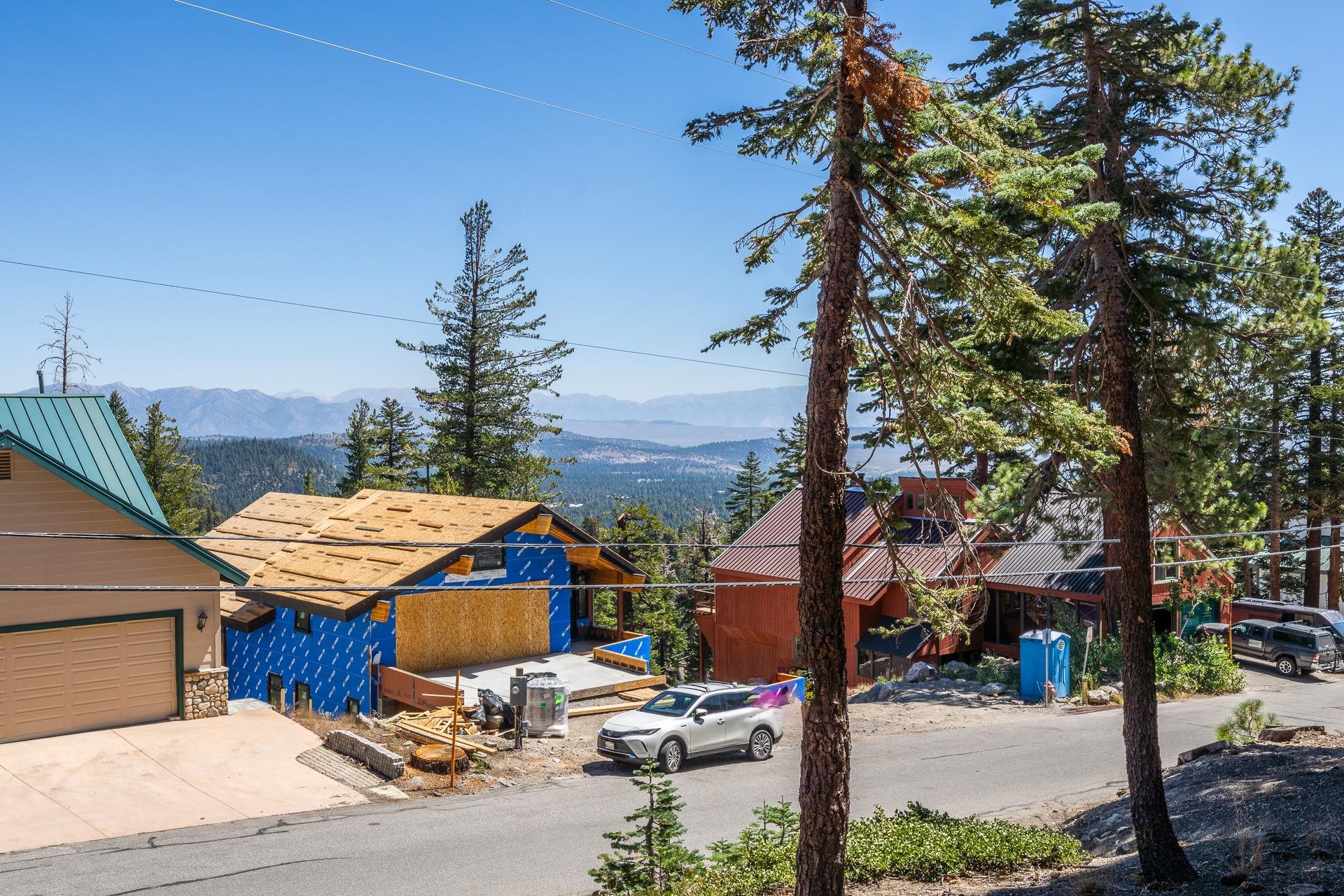 381 John Muir Road Mammoth Lakes, CA 93546 - Photo 22 of 23 a view of a patio with table and chairs with wooden fence and floor