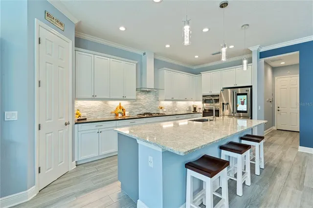 a bedroom with a bed a table and windows