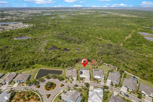 a bedroom with a bed a window and potted plant on the dresser