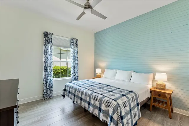 a view of swimming pool with table and chairs couches and palm trees
