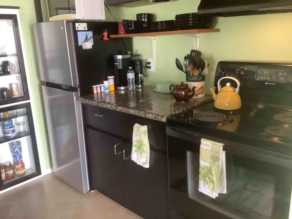 a kitchen with stainless steel appliances granite countertop a refrigerator and a stove