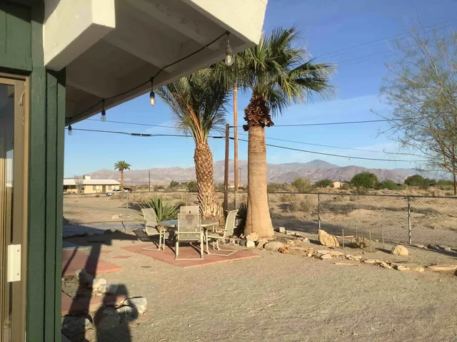 a view of a balcony with table and chairs