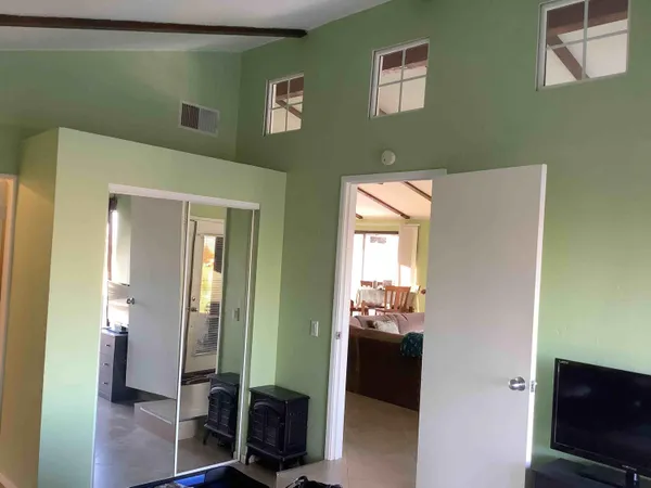 a view of a hallway with wooden floor and windows