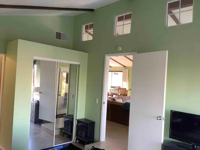 a view of a hallway with wooden floor and windows