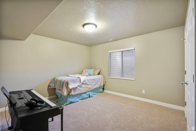 557 South 1470th Street East Springville, UT 84663 - Photo 30 of 46 Carpeted bedroom with a textured ceiling and baseboards