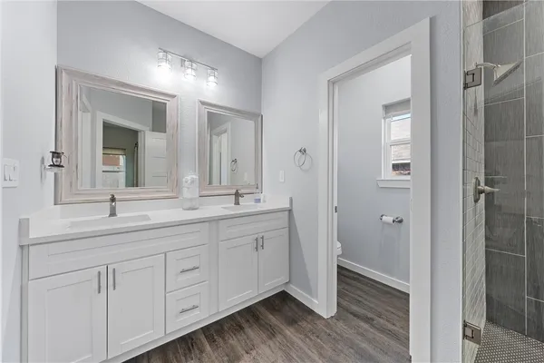 a bathroom with a double vanity sink and mirror