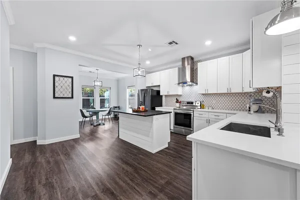 a kitchen with white cabinets and white appliances
