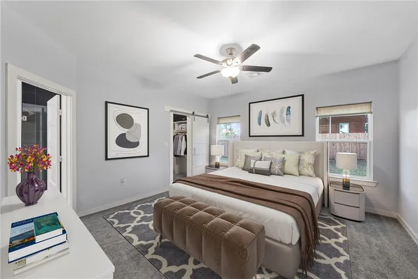 a bedroom with a bed and glass wall