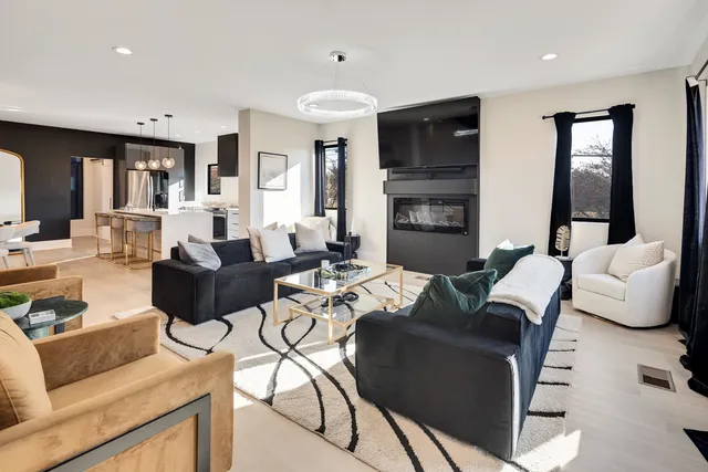 a living room with fireplace furniture and a flat screen tv