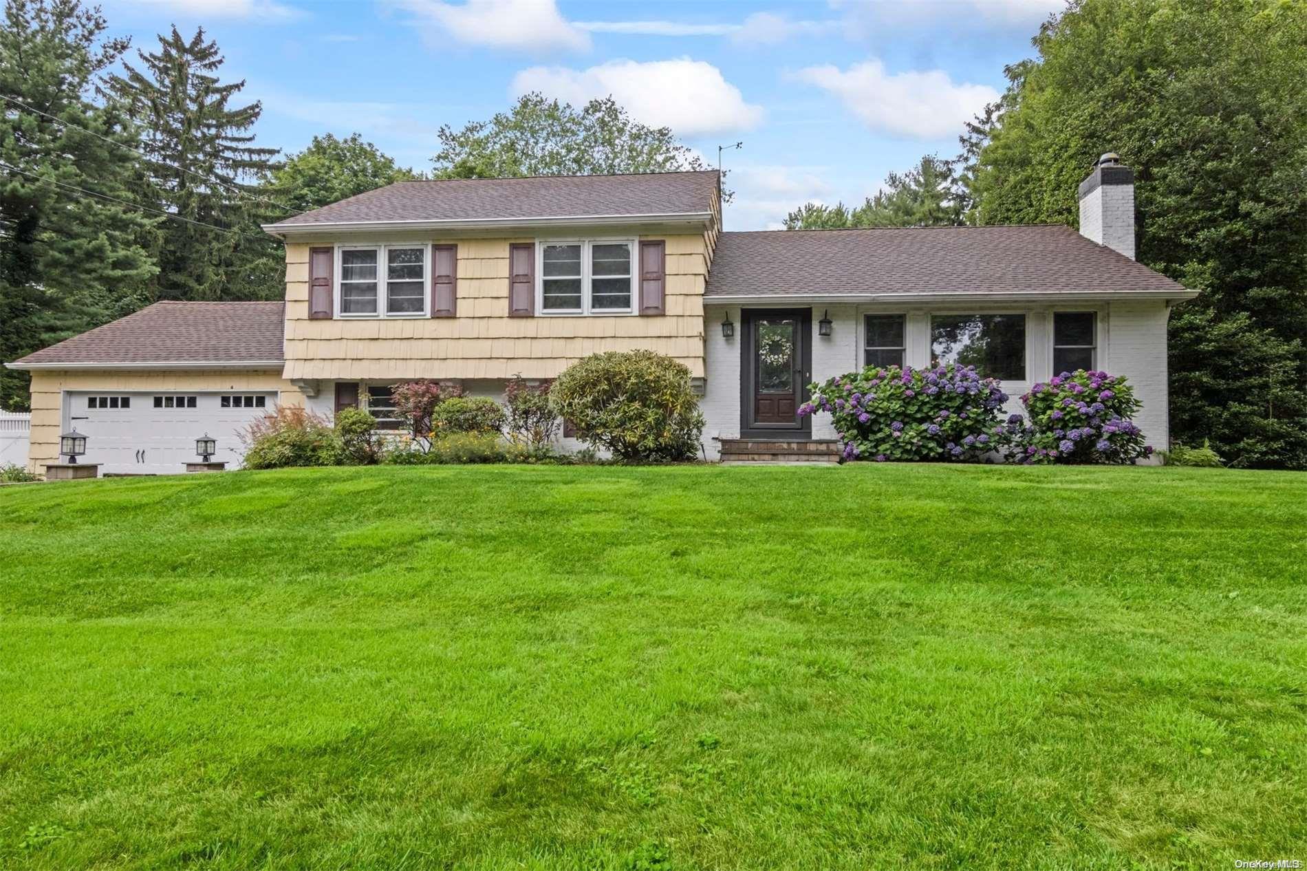 3 Salem Ridge Drive Huntington, NY 11743 - Photo 1 of 1 a front view of a house with a garden