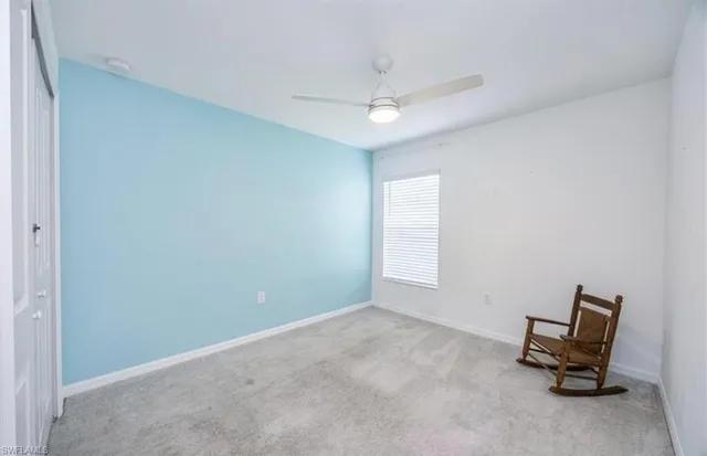 a view of room with window and ceiling fan