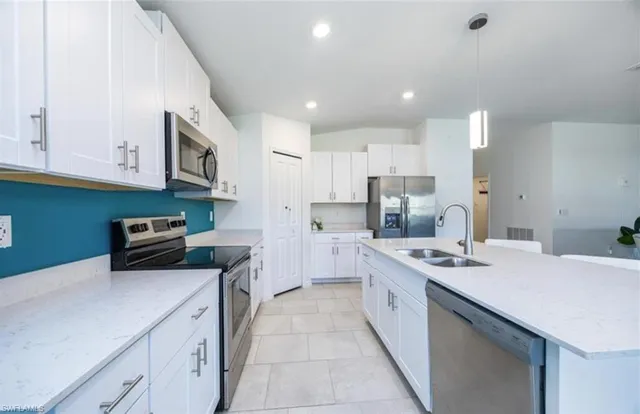 a kitchen with a sink a stove and cabinets