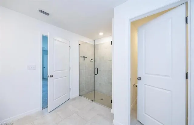 a bathroom with a shower and a sink