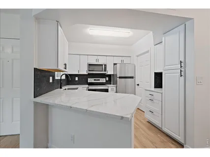 a kitchen with stainless steel appliances a refrigerator sink and cabinets