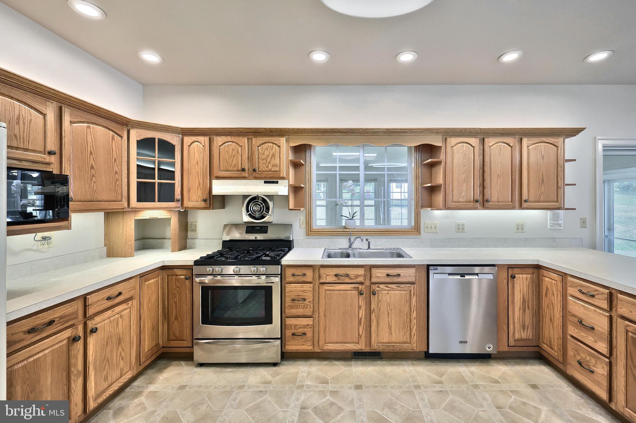 61 West McKinley Road Delta, PA 17314 - Photo 40 of 94 a kitchen with a stove sink and cabinets