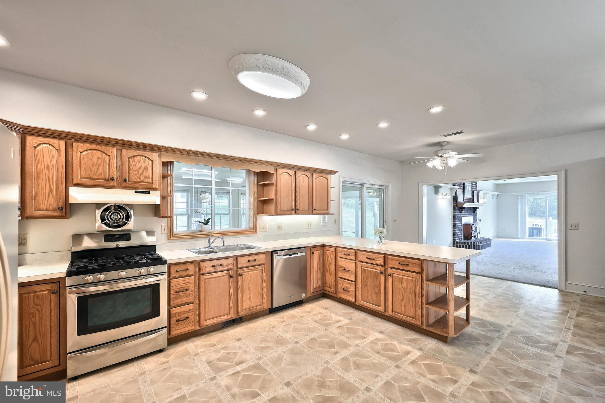61 West McKinley Road Delta, PA 17314 - Photo 43 of 94 a large kitchen with stainless steel appliances granite countertop a stove and a sink