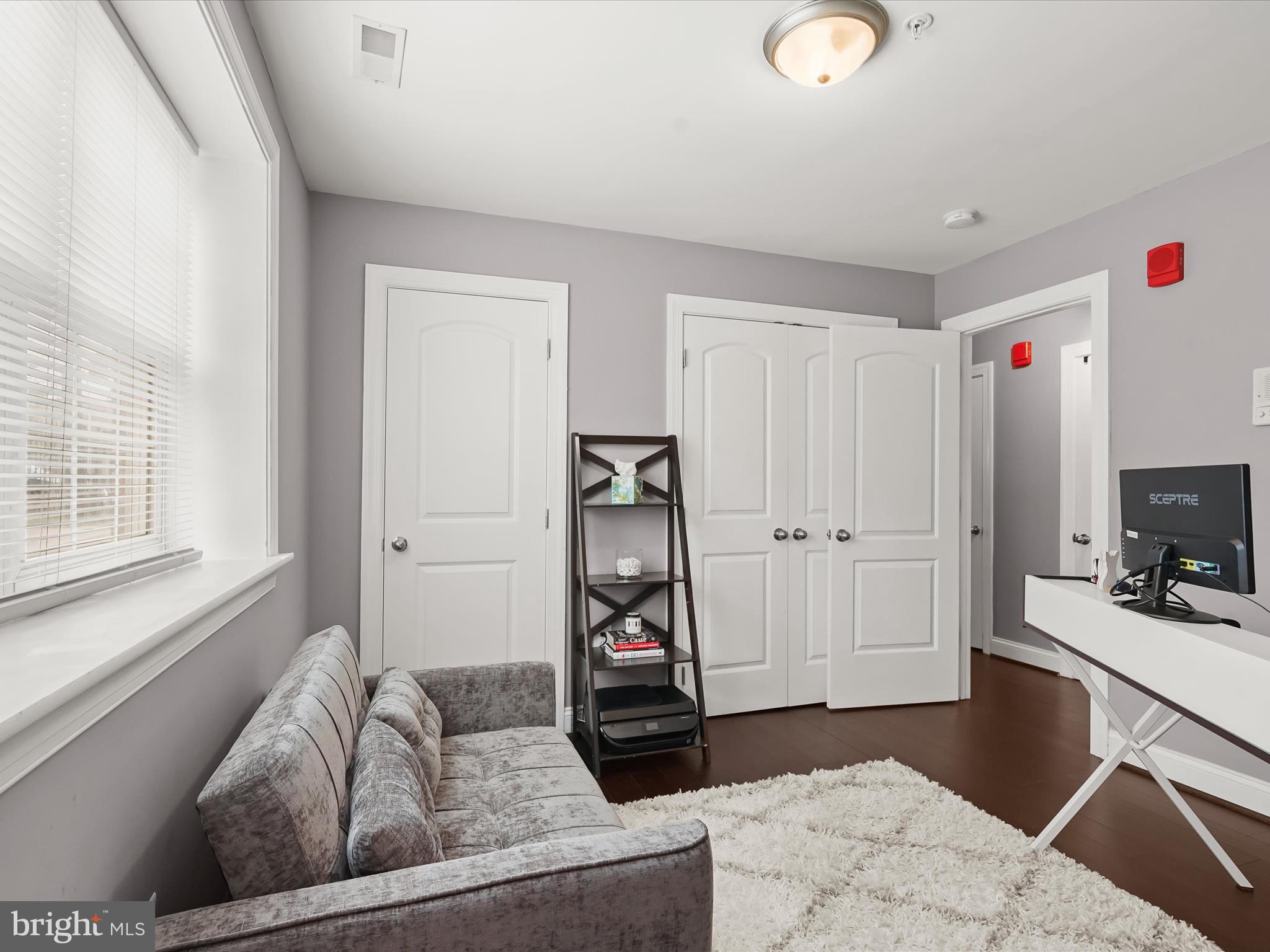 911 Kennedy Street Northwest, Unit 1 Washington, DC 20011 - Photo 14 of 18 a living room with furniture and a flat screen tv