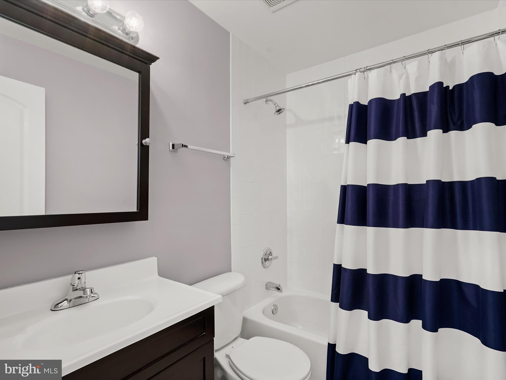 911 Kennedy Street Northwest, Unit 1 Washington, DC 20011 - Photo 16 of 18 a bathroom with a sink and a mirror