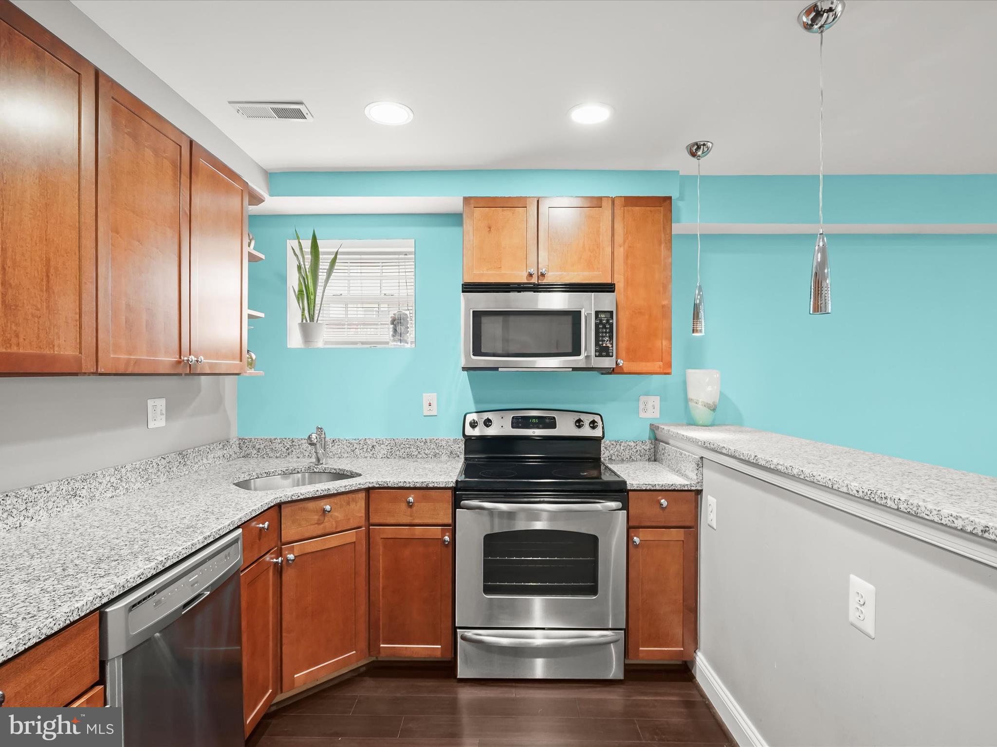 911 Kennedy Street Northwest, Unit 1 Washington, DC 20011 - Photo 4 of 18 a kitchen with granite countertop cabinets stainless steel appliances and a sink