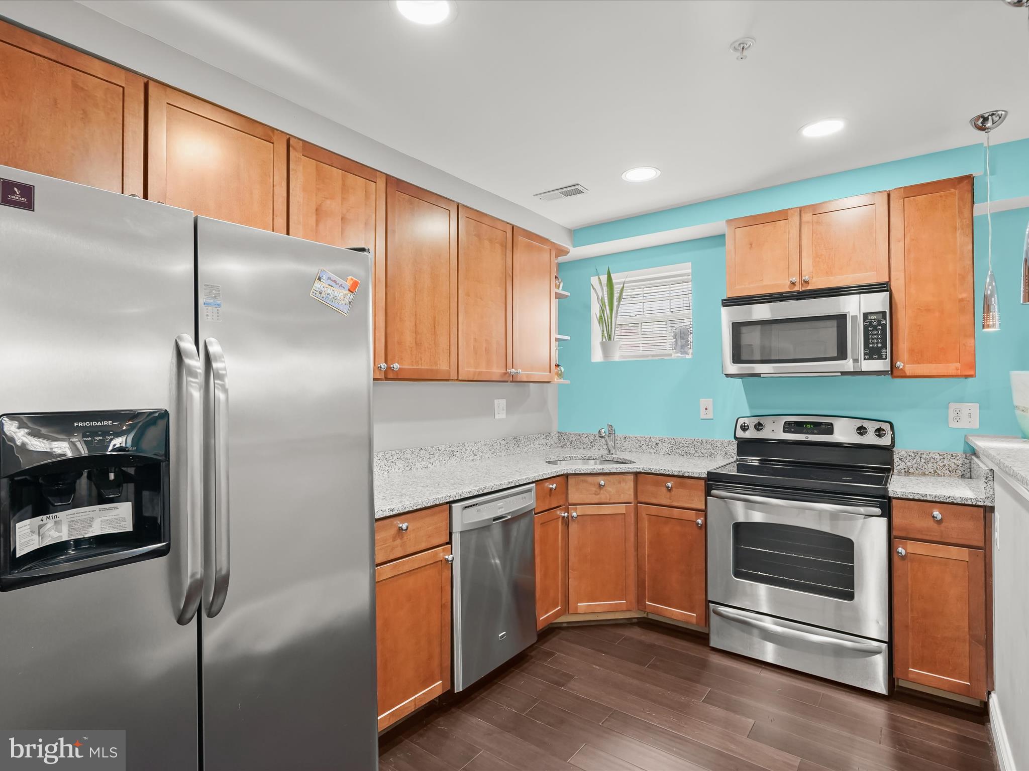 911 Kennedy Street Northwest, Unit 1 Washington, DC 20011 - Photo 5 of 18 a kitchen with stainless steel appliances granite countertop a refrigerator a stove a sink and a microwave