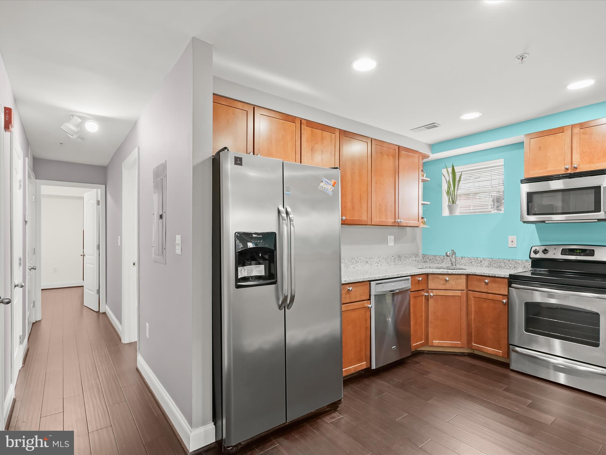 911 Kennedy Street Northwest, Unit 1 Washington, DC 20011 - Photo 6 of 18 a kitchen with stainless steel appliances granite countertop a refrigerator and a stove top oven