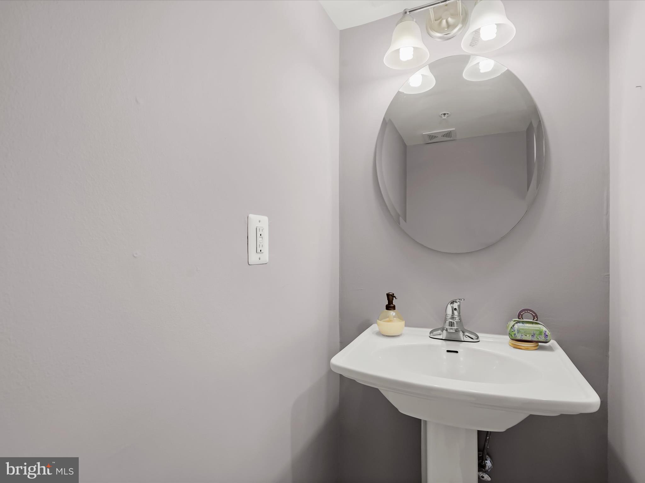 911 Kennedy Street Northwest, Unit 1 Washington, DC 20011 - Photo 7 of 18 a bathroom with a sink and a mirror