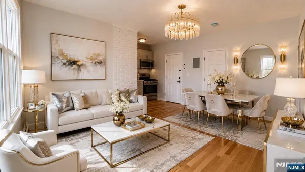 a living room with furniture a dining table and a chandelier