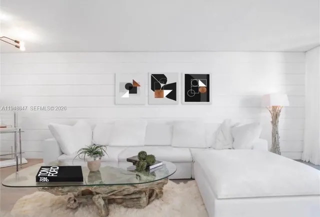 a living room with furniture and white wall