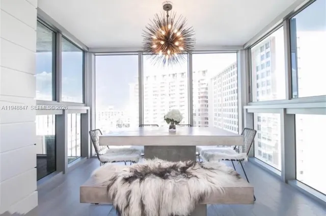 a living room with furniture and large windows