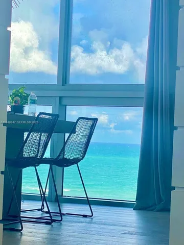 a view of a room with wooden floor and windows