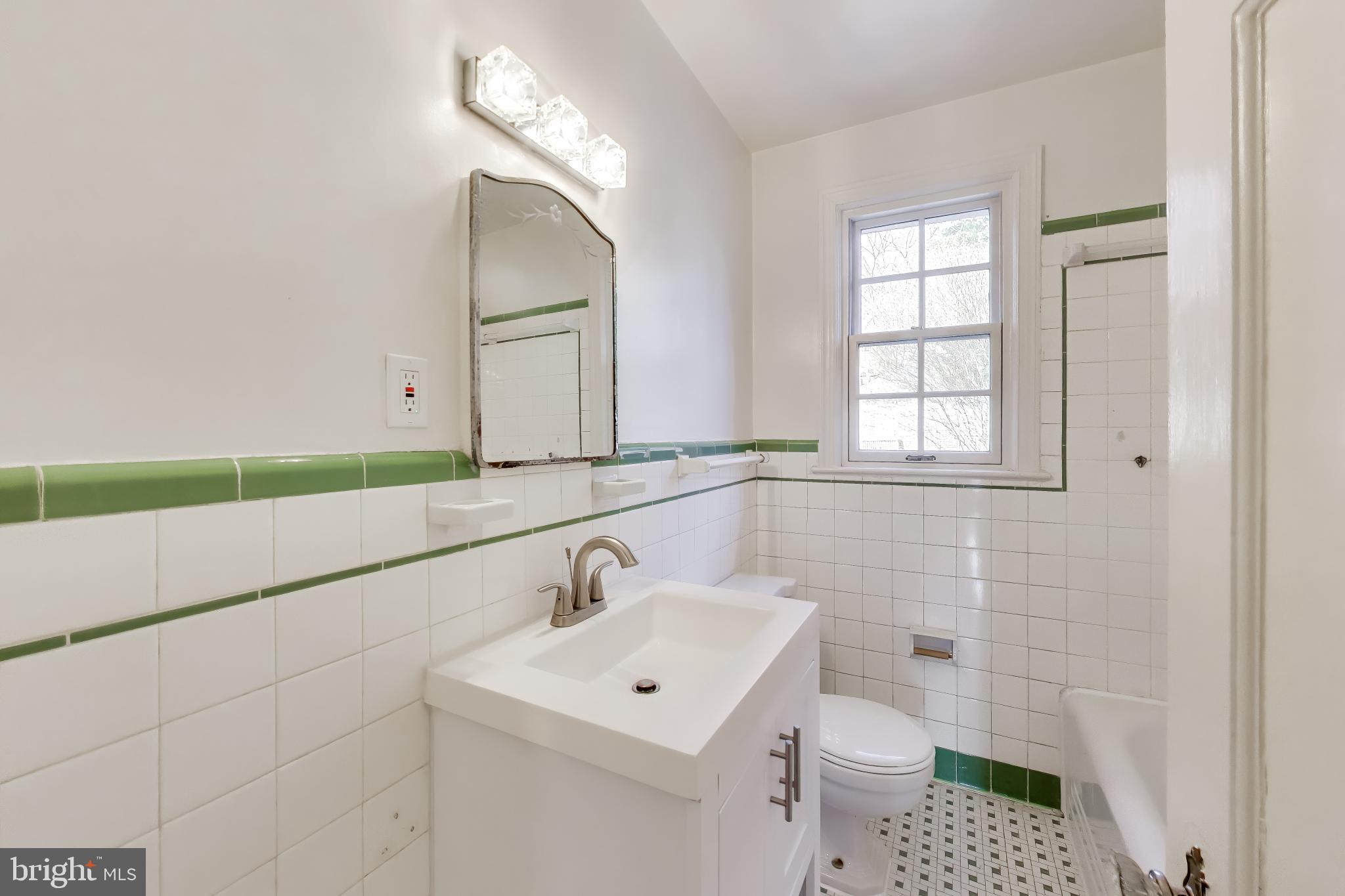5138 Nebraska Avenue Northwest Washington, DC 20008 - Photo 22 of 39 a bathroom with a sink a toilet and mirror