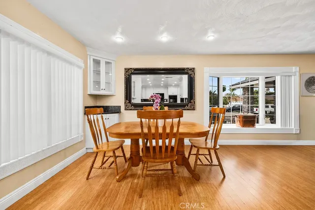 a view of a dining room with furniture window and wooden floor