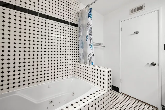 a bathroom with a bathtub and shower