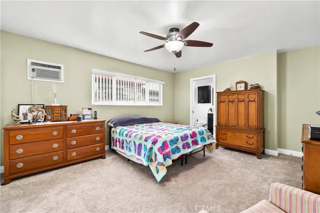 a bedroom with a bed and a dresser