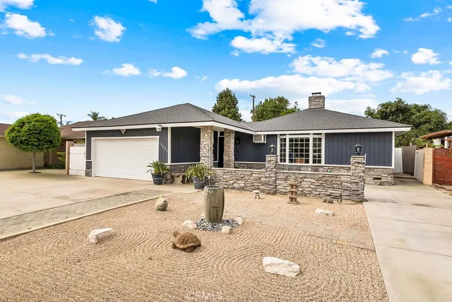 a front view of a house with garden