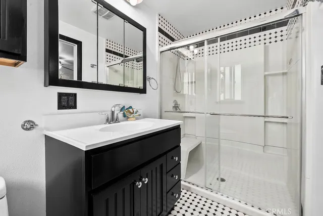 a bathroom with a sink a mirror and a shower