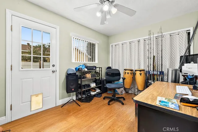 a view of a workspace with furniture and a window