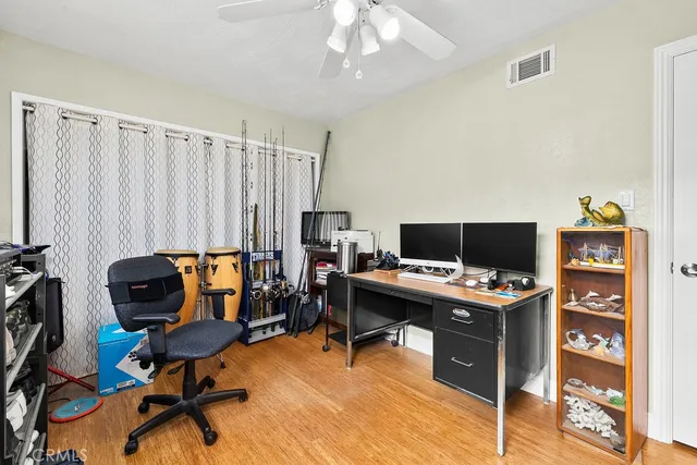 a view of a workspace with furniture and a window