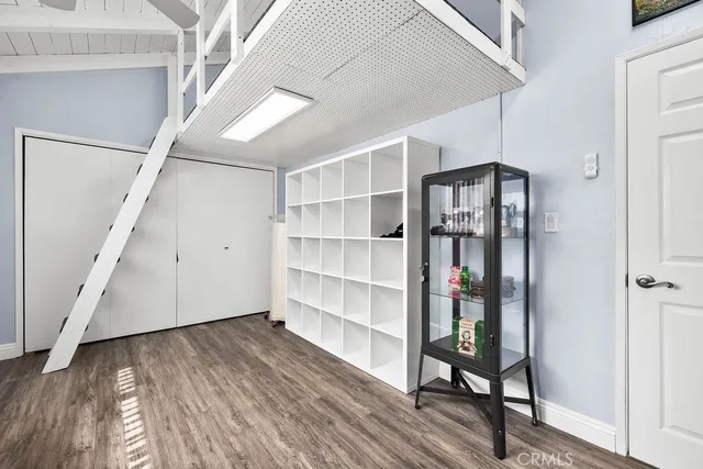 a view of a hallway with wooden floor and entryway