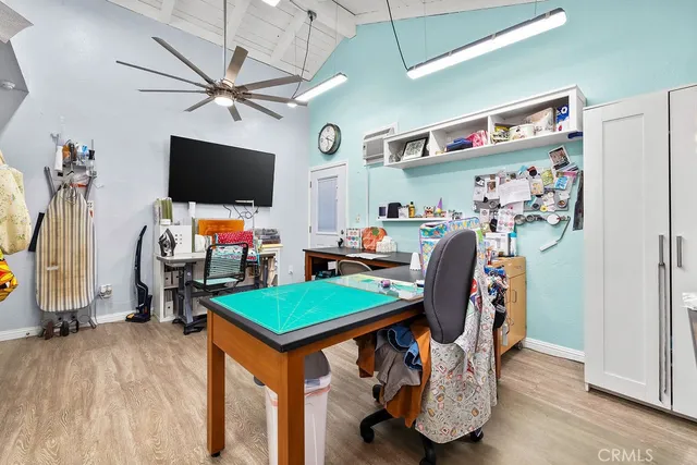 a view of a workspace with furniture and a flat screen tv