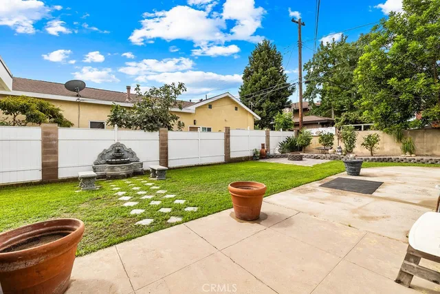 a view of a house with backyard and sitting area
