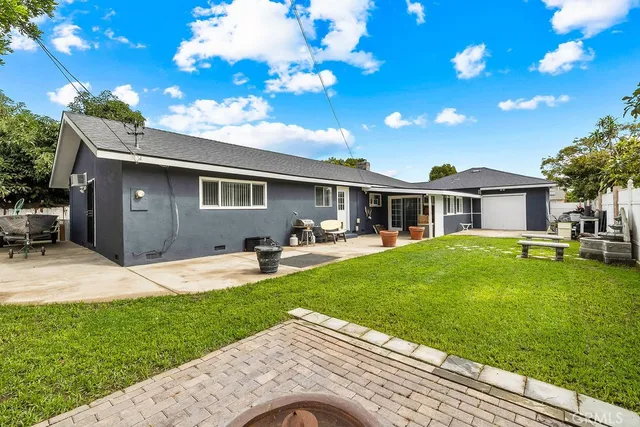 a backyard of a house with table and chairs