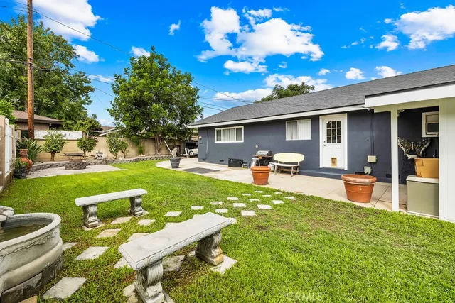 a front view of a house with garden and patio