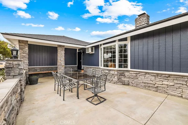 a house view with a sitting space and glass windows
