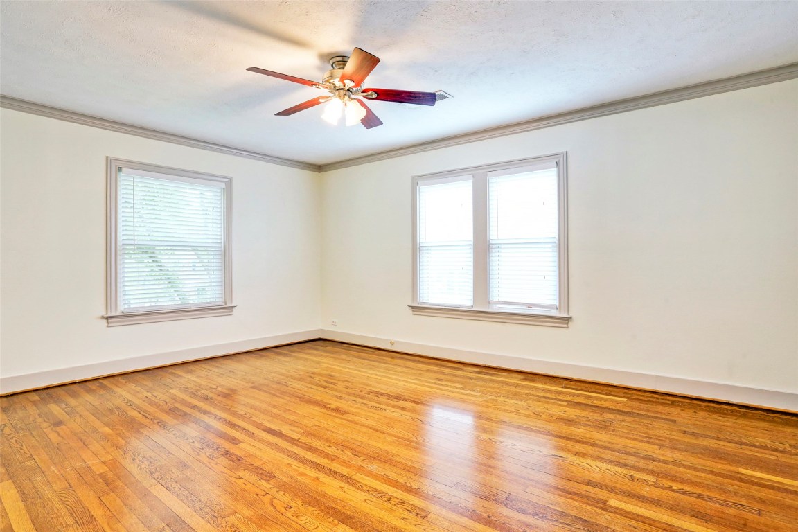 2324 Goldsmith Street, Unit B Houston, TX 77030 - Photo 6 of 19 a view of an empty room with wooden floor and a window