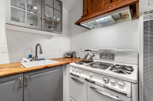 a view of a back yard of the house and car parked