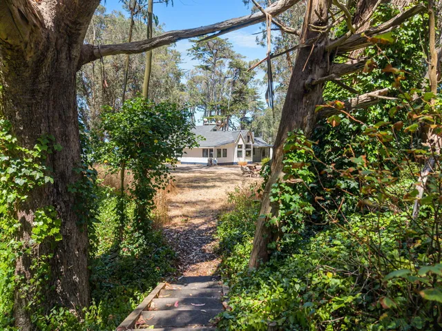 a view of a patio with table and chairs