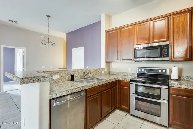 a kitchen with a sink stove top oven and microwave